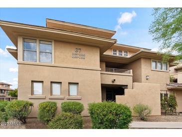 Multi-story condo building with multiple units featuring desert landscaping, stairways and architectural details at 20100 N 78Th Pl # 2203, Scottsdale, AZ 85255