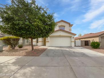 Charming two-story home with a well-manicured lawn, large tree and a spacious two car garage at 217 E Gwen St, Phoenix, AZ 85042