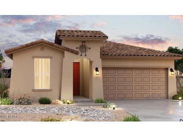 Charming single-story home featuring a tile roof, red door, and low maintenance desert landscaping at 24161 W Hilton Ave, Buckeye, AZ 85326