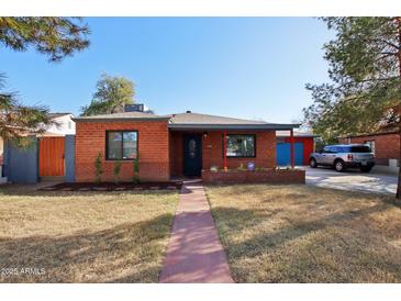Charming brick home featuring a tidy front yard and a welcoming walkway leading to the front door at 2511 E Pinchot Ave, Phoenix, AZ 85016