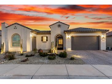 Charming single-story home with landscaped front yard and desert landscaping under a colorful dusk sky at 26999 W Ponderosa Ln, Buckeye, AZ 85396
