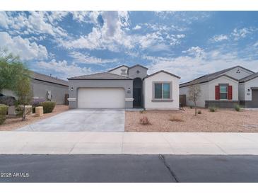 Charming single-story home featuring a two-car garage and low-maintenance desert landscaping at 31045 W Mulberry Dr, Buckeye, AZ 85396