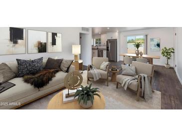 Bright living area showcasing modern décor, stylish furnishings, and a seamless flow to the dining space at 3330 E Palm Ln, Phoenix, AZ 85008