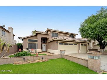 Beautiful two-story home featuring a three-car garage and well-manicured lawn at 7971 W Montebello Ave, Glendale, AZ 85303