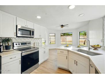 Bright, updated kitchen featuring white cabinets, stainless appliances, and bar sink at 1918 E Anchor Dr, Gilbert, AZ 85234