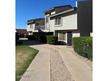 Inviting two-story townhome with a well-maintained landscape and a private walkway at 19601 N 7Th N St # 1032, Phoenix, AZ 85024