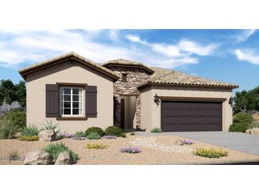 Charming single-story home with stone accents, a two-car garage, and desert landscaping at 20445 W Rovey Ave, Buckeye, AZ 85396
