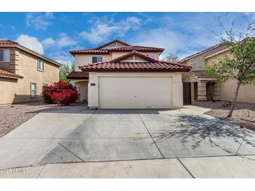 Charming two-story home featuring a red tile roof and spacious two-car garage at 22787 W Gardenia Dr, Buckeye, AZ 85326