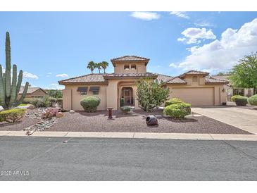 Charming single-story home featuring desert landscaping, a tiled roof, and an attached two car garage at 2862 N 156Th Dr, Goodyear, AZ 85395