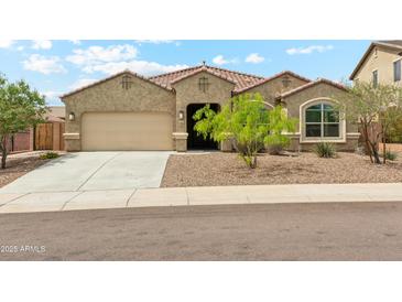 Charming single-story home featuring a well-manicured front yard and attached two-car garage at 31096 N 133Rd Ave, Peoria, AZ 85383