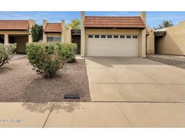 Charming single-story home featuring a red tile roof, a two-car garage, and desert landscaping at 5358 S Farmer Ave, Tempe, AZ 85283