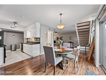 Dining area with a round table, seating for four, and modern lighting at 5632 S Hurricane Ct # C, Tempe, AZ 85283