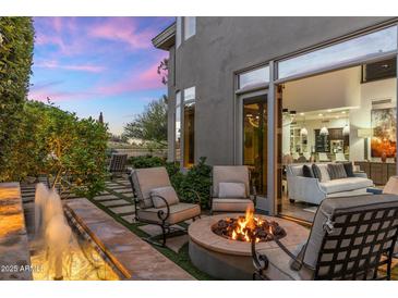 Outdoor patio with a water feature, fire pit, and seating, perfect for enjoying evenings at 6929 E Montreal Pl, Scottsdale, AZ 85254