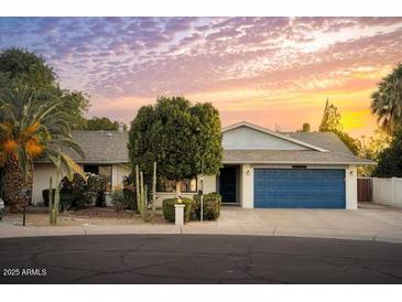 Charming single story home featuring a large driveway and a two car garage with lush landscaping at 7412 S Elm St, Tempe, AZ 85283