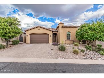 Charming single-story home with desert landscaping, a paver driveway, and a two-car garage at 10713 N 124Th Pl, Scottsdale, AZ 85259