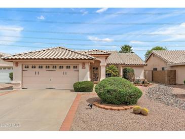 Charming single-story home featuring a two-car garage and attractive desert landscaping at 11925 N 67Th Dr, Peoria, AZ 85345