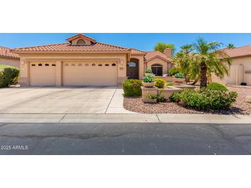 Charming single-story home featuring a three-car garage and lush landscaping, perfect for curb appeal at 16151 W Fairmount Ave, Goodyear, AZ 85395