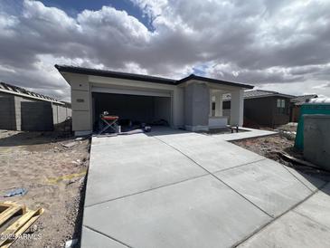 Modern single-story home with wide driveway and covered front porch under construction at 17293 W Desert Sage Dr, Goodyear, AZ 85338
