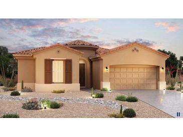 Charming single-story home with desert landscaping, a barrel tile roof, and an attached two-car garage at 20263 W Catalina Dr, Buckeye, AZ 85396