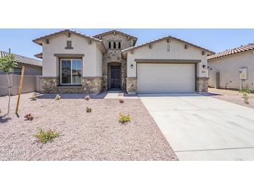 Charming single-Gathering home featuring stone accents, neutral stucco, a two-car garage, and low-maintenance landscaping at 20263 W Catalina Dr, Buckeye, AZ 85396
