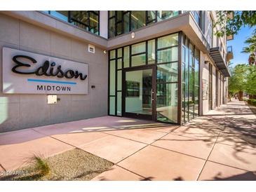 Modern condo building entrance with glass doors and prominent signage for Edison Midtown at 3131 N Central Ave # 7002, Phoenix, AZ 85012