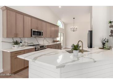 Modern kitchen with quartz countertops, stainless steel appliances, and stylish cabinetry at 4010 N 156Th Ln, Goodyear, AZ 85395