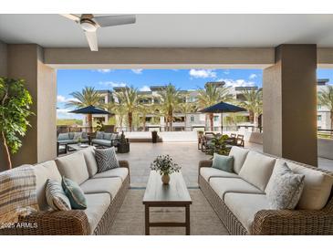 Inviting covered patio with wicker furniture and views of lush landscaping and community amenities at 5250 E Deer Valley Dr # 206, Phoenix, AZ 85054