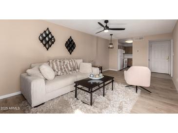 Inviting living room with comfortable seating, modern decor, and wood laminate flooring at 5518 E Lindstrom Ln # 3012, Mesa, AZ 85215