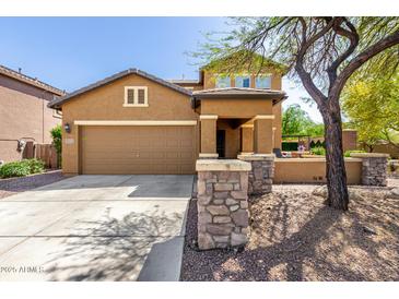 Charming two-story home featuring a two-car garage, inviting front porch, and low maintenance desert landscaping at 7359 W Kings Ave, Peoria, AZ 85382