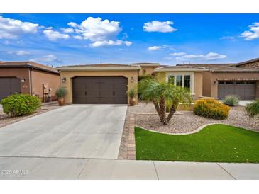 Charming single-story home featuring a well-manicured yard, a two-car garage and neutral color palette at 77 E Atole Ct, Queen Creek, AZ 85140
