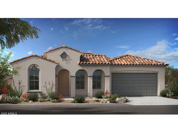 Charming single-Gathering home featuring stucco siding, a tile roof, arched windows and a two-car garage at 20723 W San Miguel Ave, Buckeye, AZ 85396