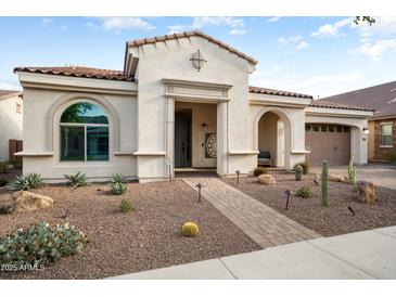 Charming single-story home featuring a desert landscape, tile roof, and inviting front entrance at 20977 W Mariposa St, Buckeye, AZ 85396