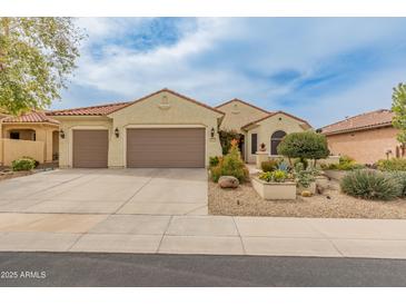 Charming single-story home with a well-maintained front yard and a two-car garage at 26473 W Runion Ln, Buckeye, AZ 85396