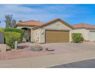 Charming single-Gathering home showcasing a well-maintained yard and a two-car garage, offering both comfort and convenience at 30430 N 42Nd Pl, Cave Creek, AZ 85331
