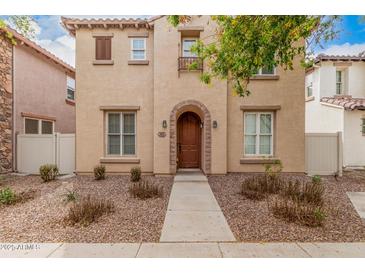 Charming two-story home with a warm beige exterior, arched entry, and well-maintained front yard at 3591 S Ranger Trl, Gilbert, AZ 85297