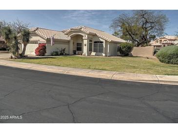 Charming single-story home with a well-manicured lawn and classic desert landscaping at 4172 E Graythorn Ave, Phoenix, AZ 85044