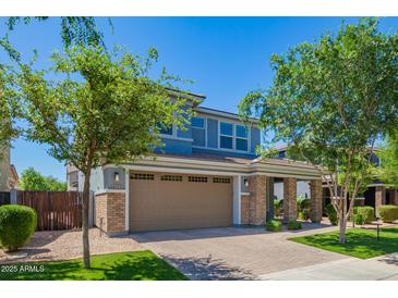 Charming two-story home with a brick facade, a two-car garage, and lush landscaping at 4253 E Palo Verde St, Gilbert, AZ 85296