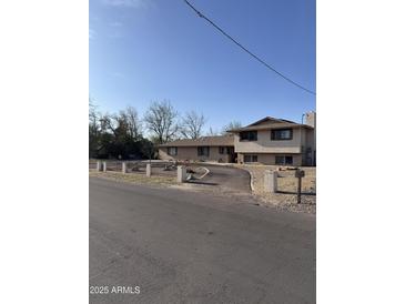 Charming exterior view of a two-story home with a driveway and landscaped front yard at 4332 W Monte Cristo W Ave, Glendale, AZ 85306