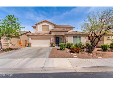 Charming two-story home featuring a well-manicured front yard and a spacious two-car garage at 17538 W Marshall Ln, Surprise, AZ 85388