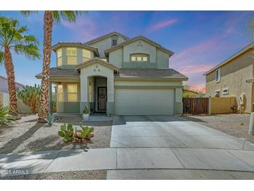 Charming two-story home with desert landscaping, a two car garage and a welcoming front entrance at 2850 N 152Nd Ln, Goodyear, AZ 85395