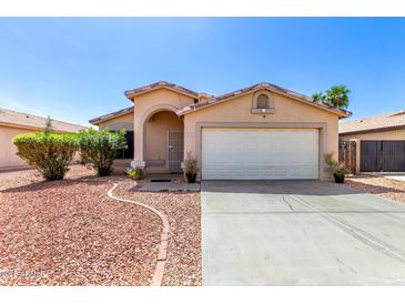 Charming single-story home featuring a well-maintained front yard and attached two-car garage at 8741 W Manzanita Dr, Peoria, AZ 85345