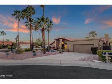 Single-Gathering home with desert landscaping, tall palm trees, and tile roof at 10484 E Mission Ln, Scottsdale, AZ 85258