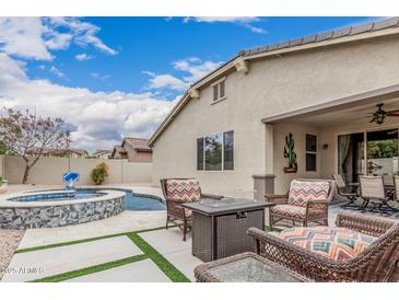 A private outdoor living space with pool, spa, patio, and fire pit at 1078 W Redwood Ave, Queen Creek, AZ 85140
