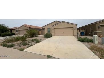 Charming single-story home featuring a low-maintenance desert landscape and a two-car garage at 13142 E Aster Ln, Florence, AZ 85132