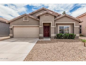 Charming single-story home featuring a two-car garage and a well-maintained front yard at 15829 W Boca Raton Rd, Surprise, AZ 85379