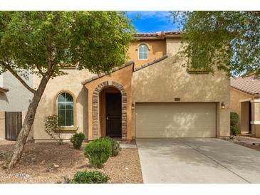 Charming two-story home with arched entry, desert landscaping, and two-car garage at 17507 N Costa Brava Ave, Maricopa, AZ 85139