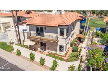 Charming two-story home boasting a balcony, tiled roof, and lush landscaping at 8841 S 51St St # 1, Phoenix, AZ 85044