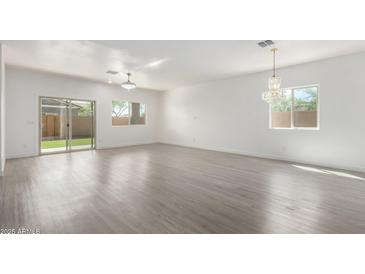 Bright, open living room featuring hardwood floors and a sliding glass door at 947 E Wiley Way, Casa Grande, AZ 85122