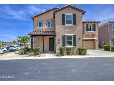 Charming two-story home with well-maintained landscaping and a welcoming front porch at 9923 E Tahoe Ave, Mesa, AZ 85212