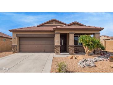 Charming single-story home featuring a well-manicured yard and covered porch at 23728 W Magnolia Dr, Buckeye, AZ 85326